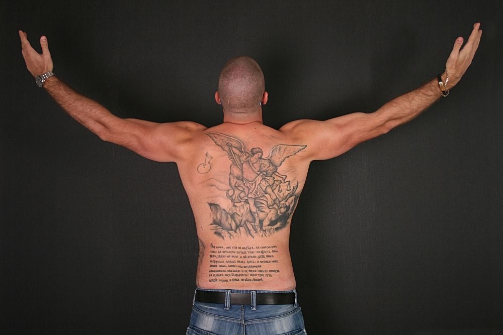 A man with tattoos in back