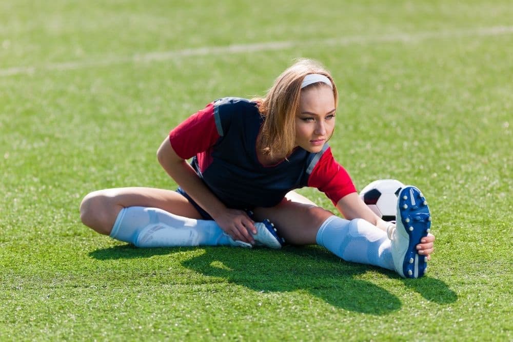 A woman player is warming up before a soccer match