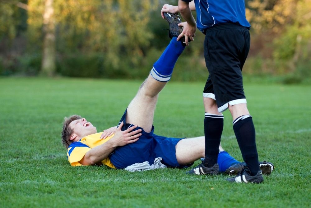 The player gets an injury on the soccer field