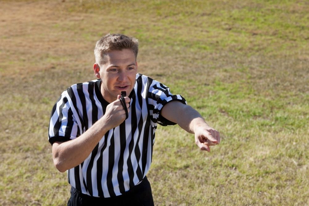 The referee is about to blow his whistle