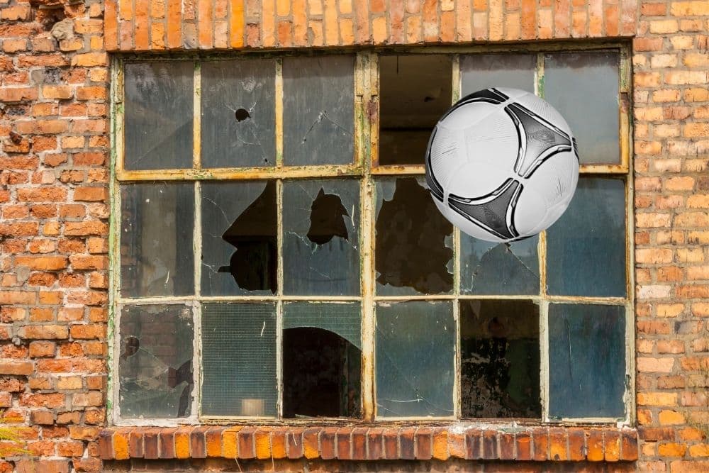 The soccer ball is the culprit that breaks the window
