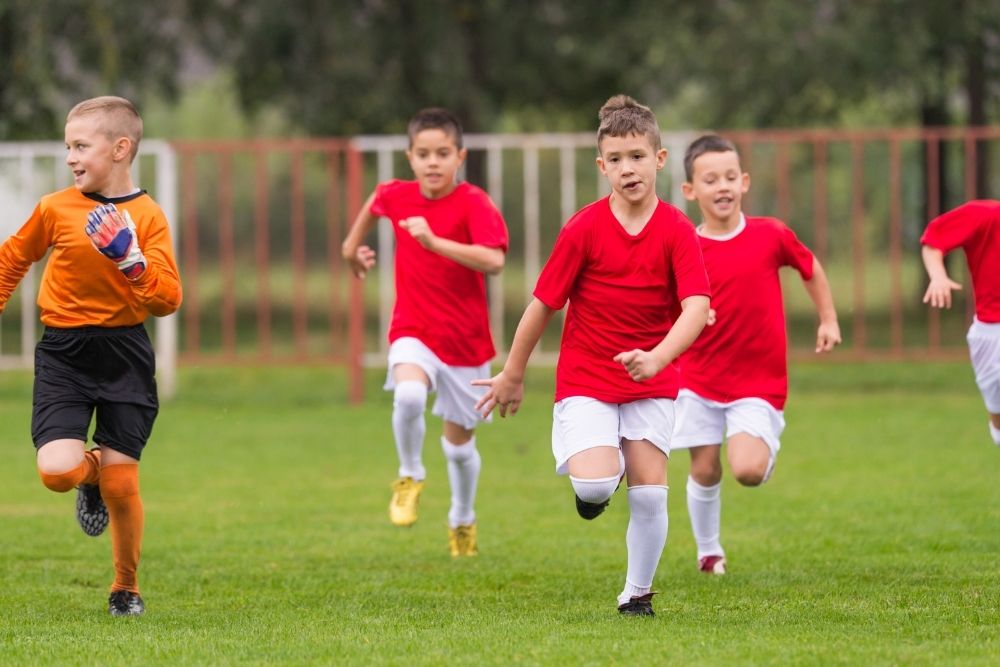 Young soccer players are sprinting in their training session