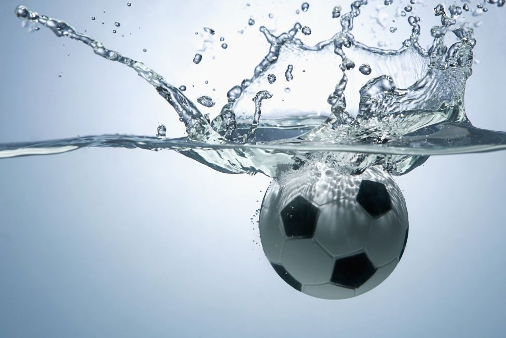 A soccer ball is dropped into the water