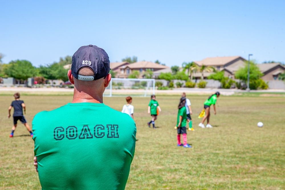 A soccer coach is tracking the training session of young players
