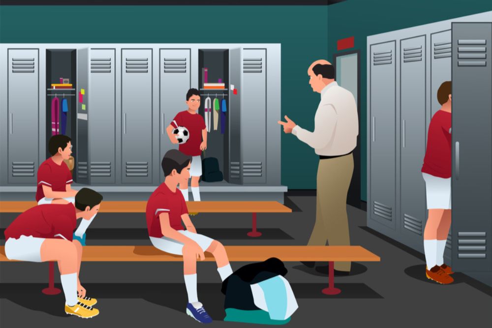 Soccer players in the locker room and are listening to the coach (1)