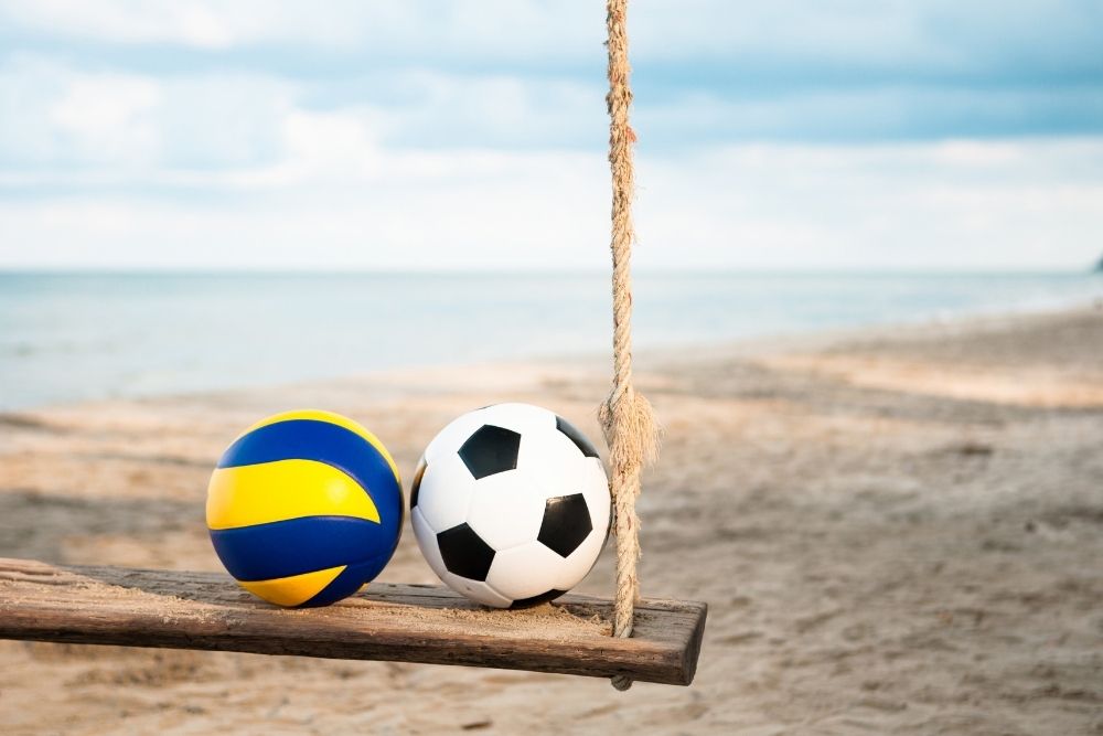 a soccer ball and a volleyball are placed side by side