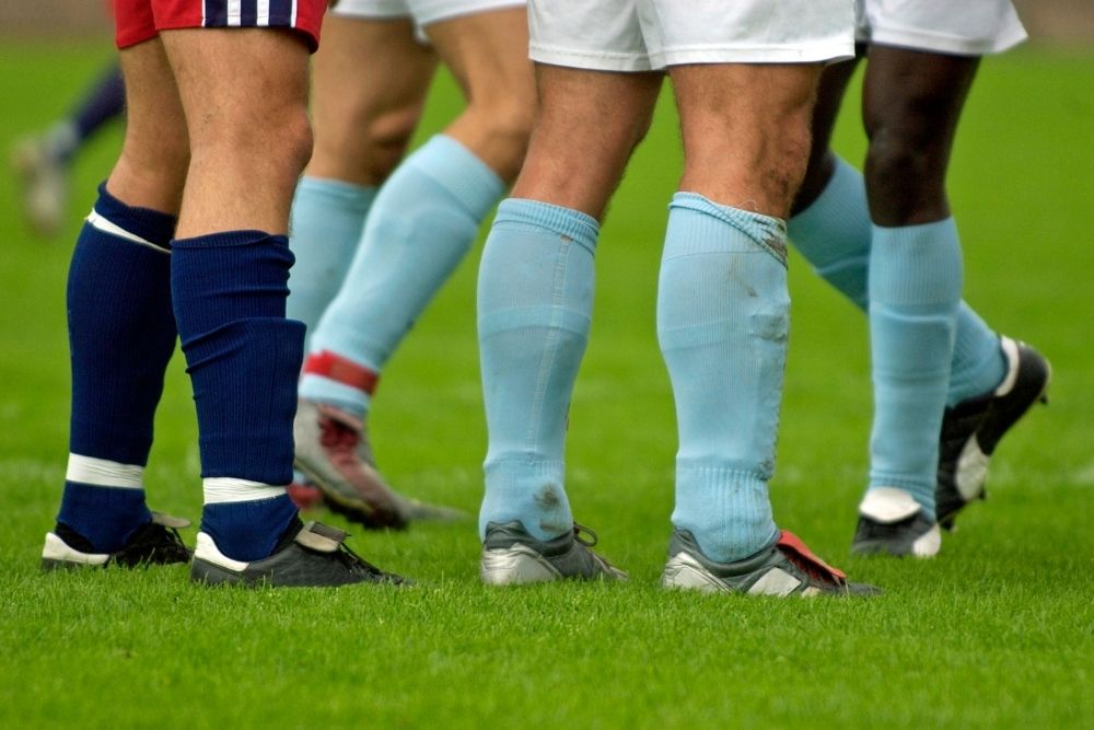 some players with tight calves standing on the field