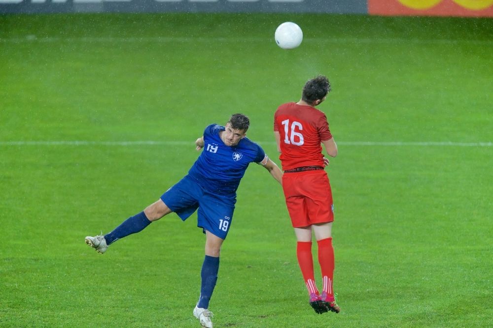 the player in red is making a header