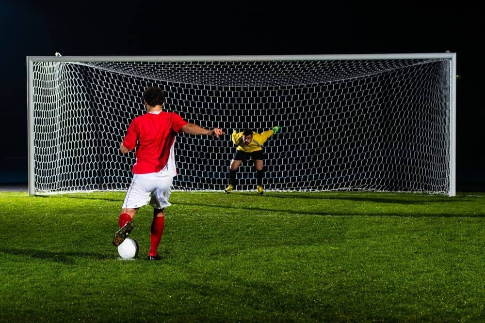 the player in red is taking a penalty