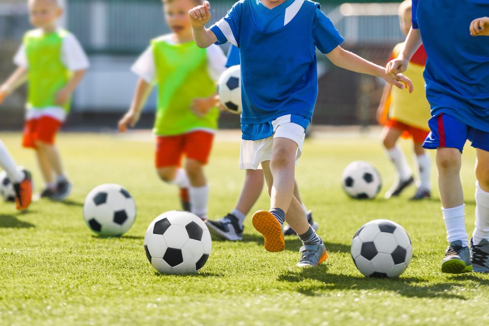 Young soccer player in training course