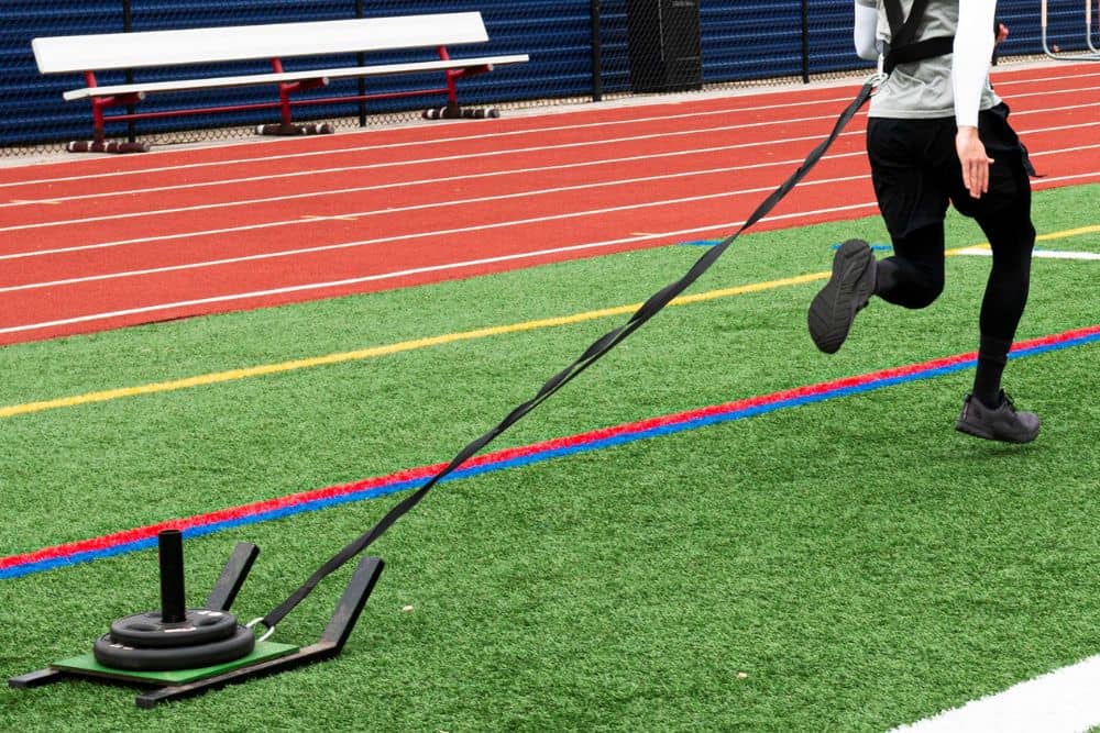 a person doing weighted sled drag