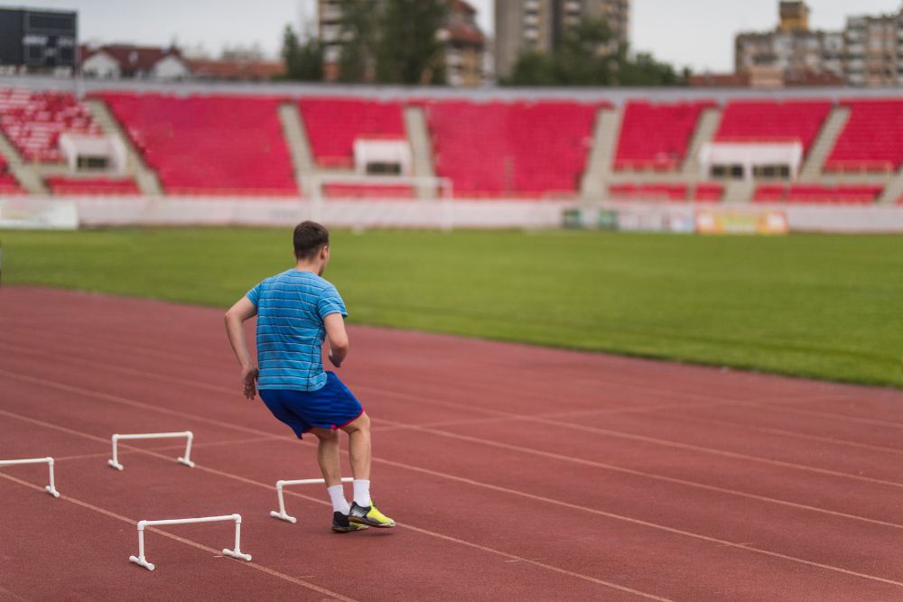 a soccer player pratices lateral hurdle sprints