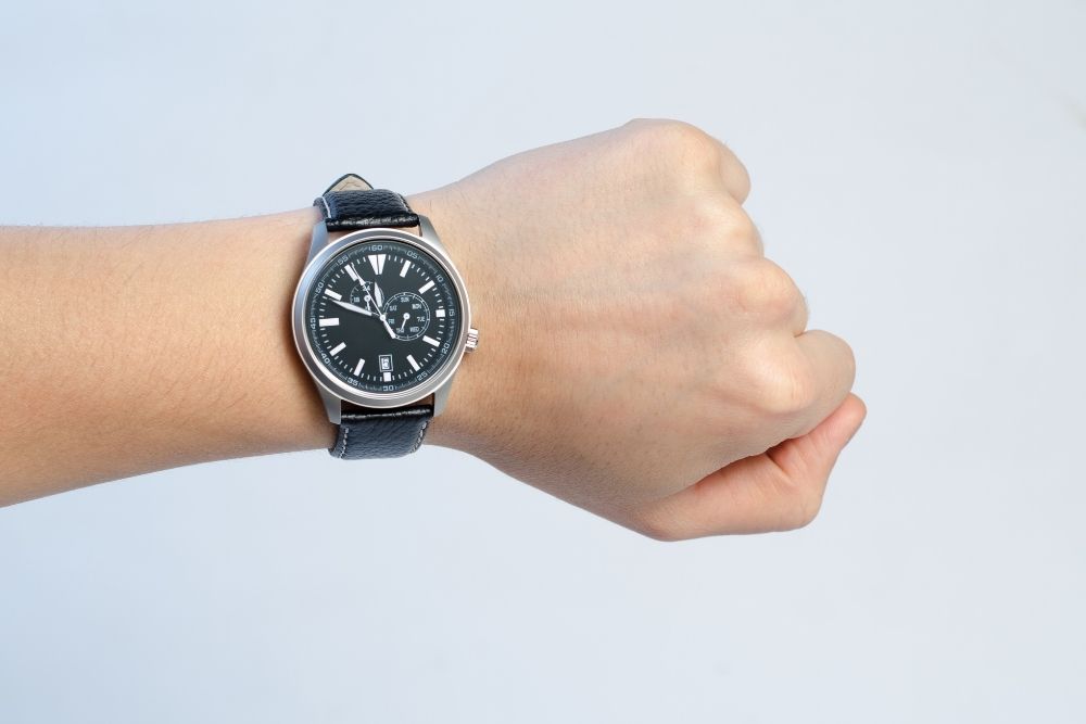 hand wearing black watch