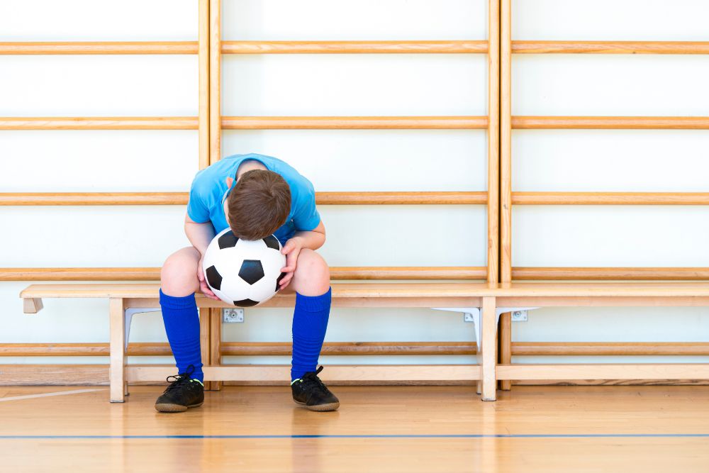sad soccer player in the locker room