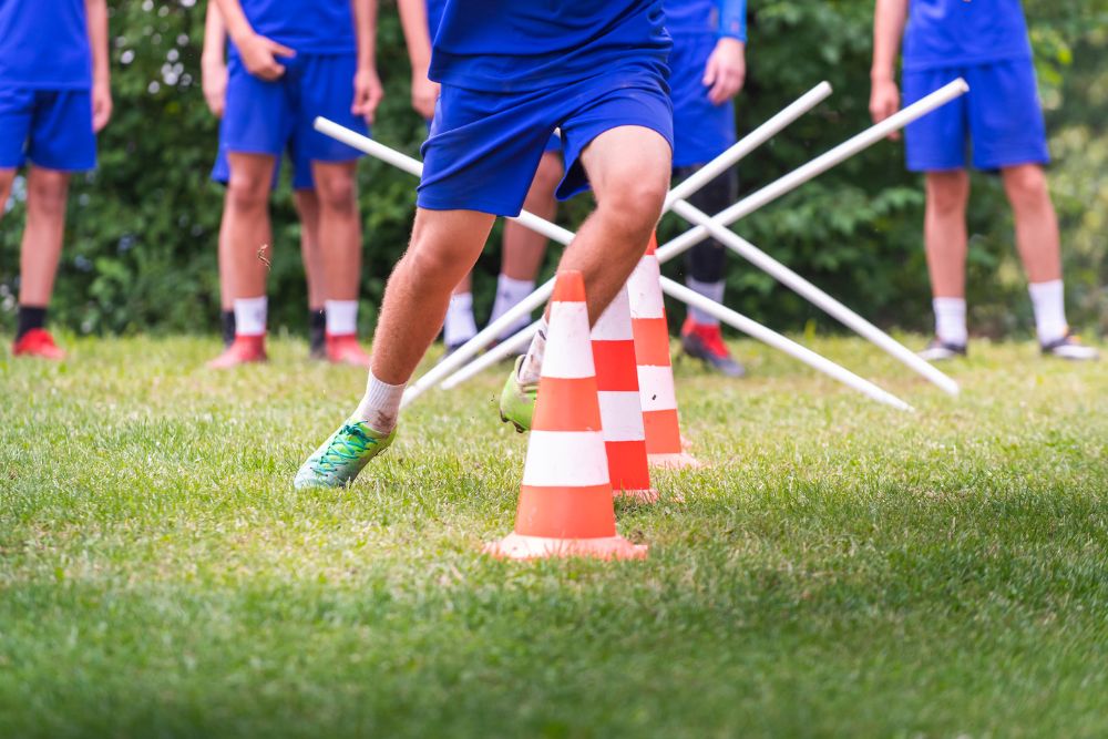 soccer players practice with cones