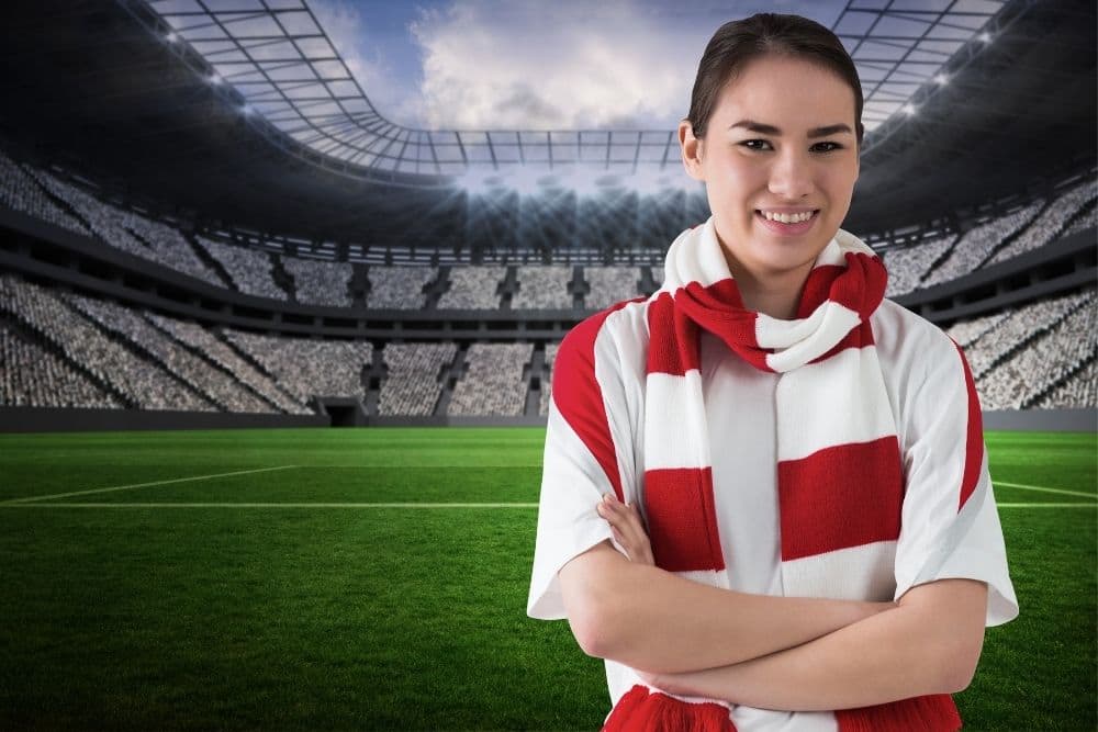 A girl wearing the scarf is standing at the stadium