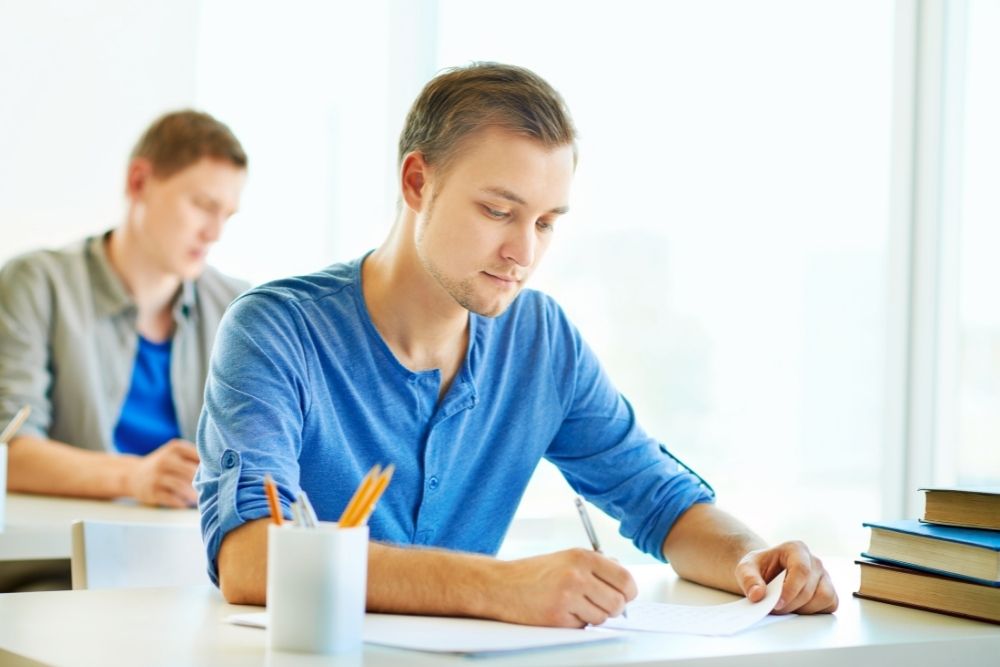 A man is Taking a written exam
