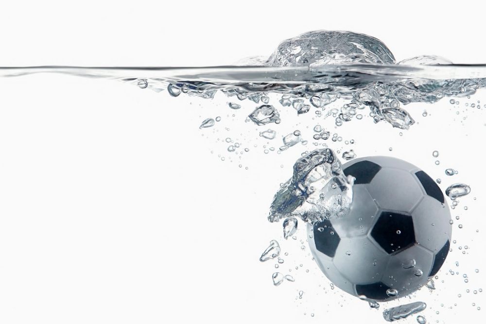 A soccer ball is soaked into the water