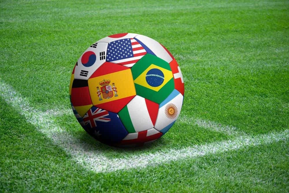 A soccer ball printed with national flags is lying in the corner of the field