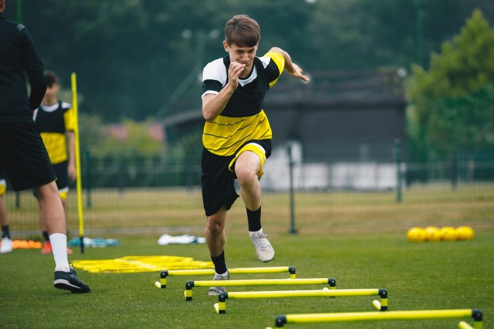 A soccer player is running in the training session