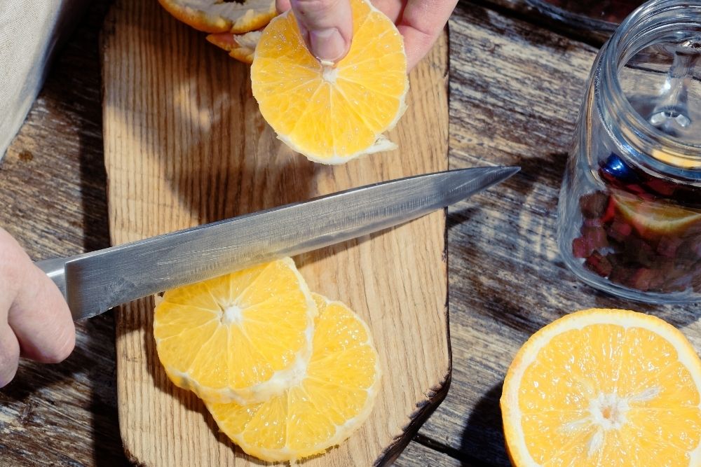 Cut orange into wheel slices
