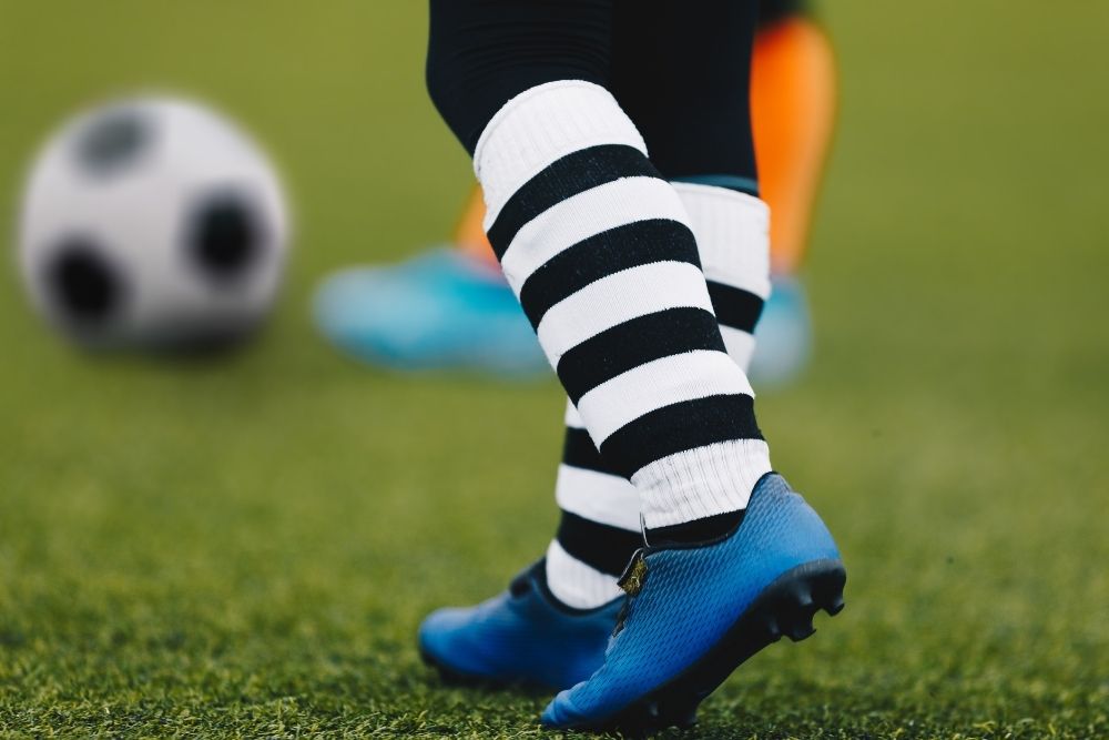 Soccer player wear blue shoes and long socks