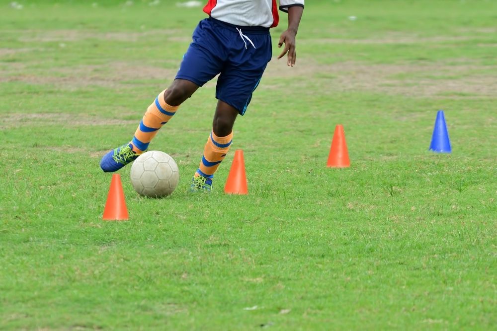 The player is practicing dribbling