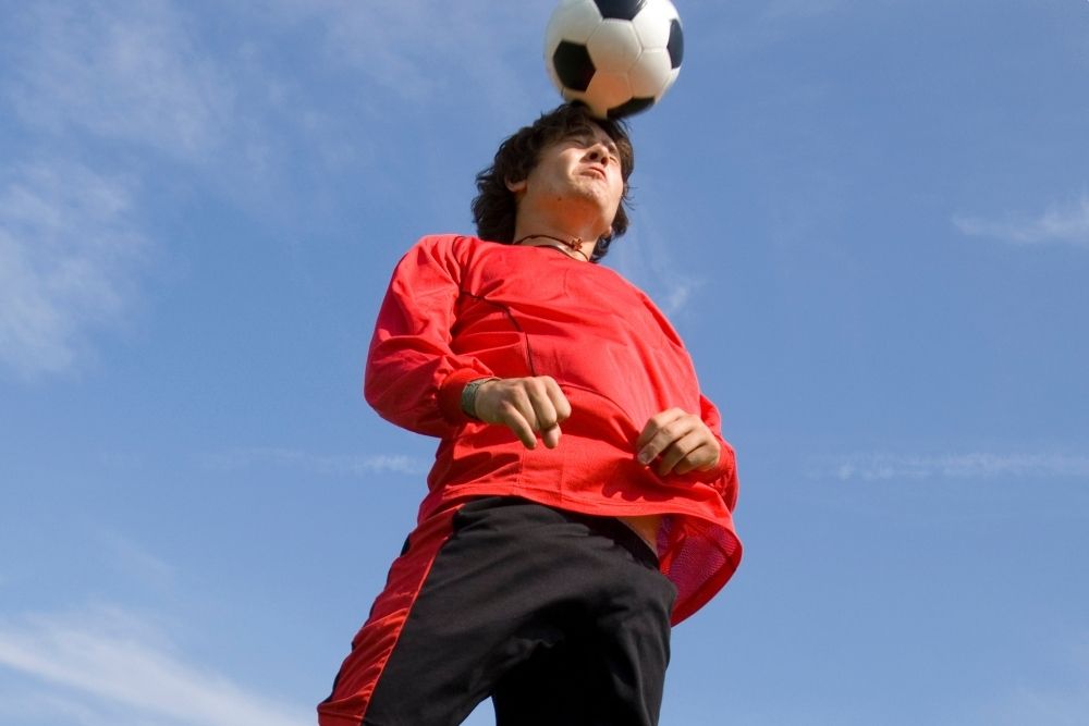 The player is taking a header