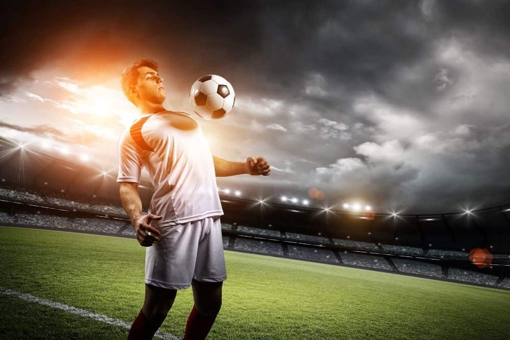 The soccer player is controlling a ball by chest
