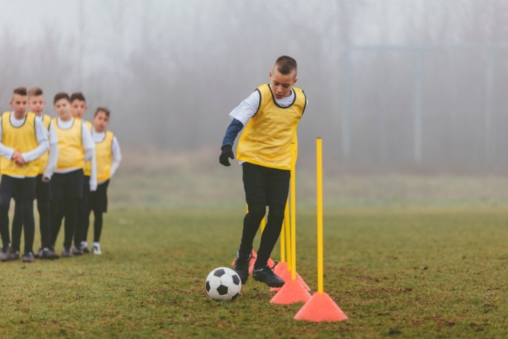 a young player is dribbling in a training session