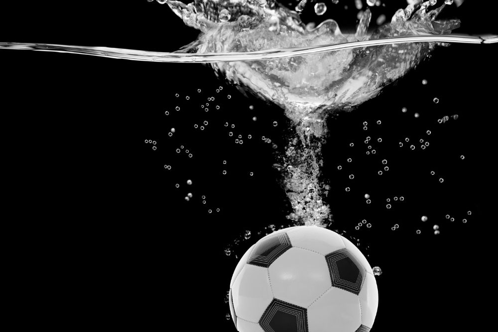 the soccer ball is soaked into the water