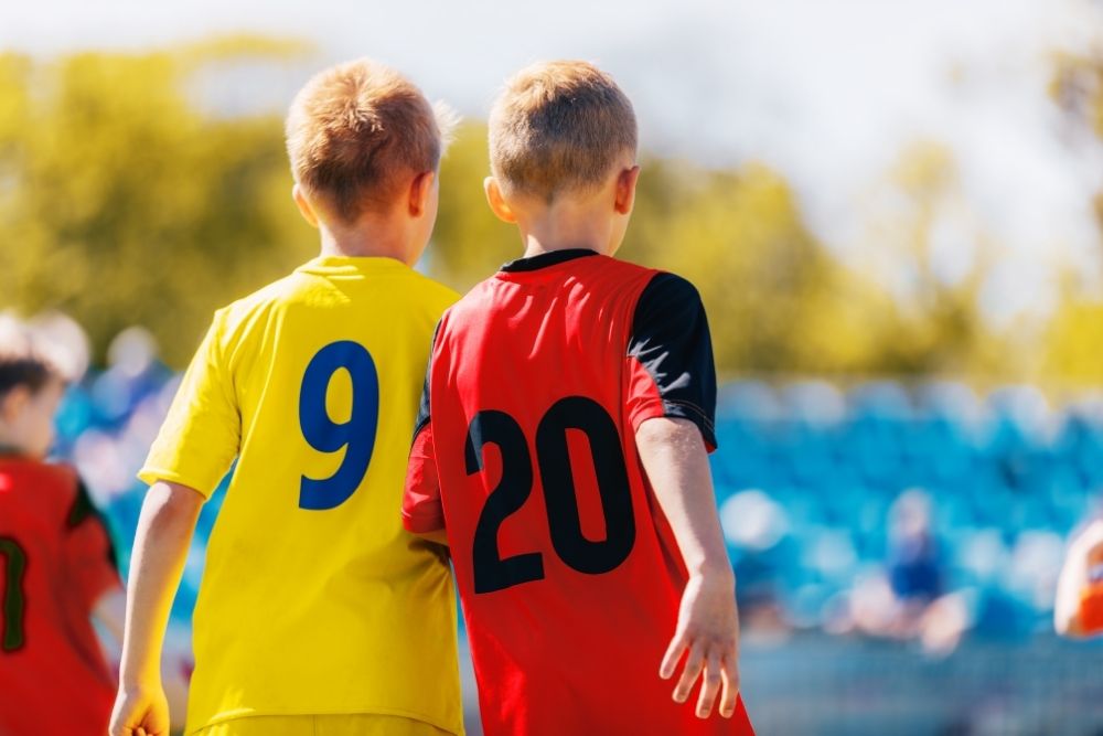 two kids wearing number 9 and 20 soccer jerseys