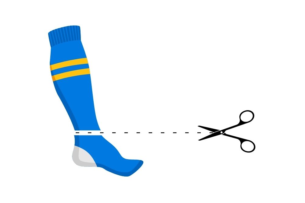 use scissor to cut a blue soccer sock