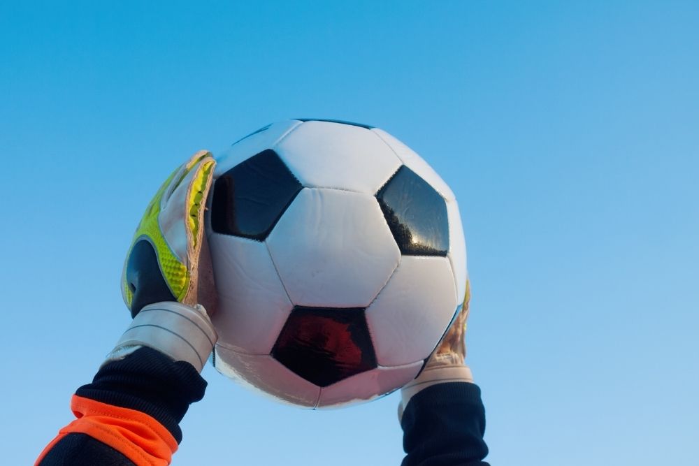 Soccer goalie hold the ball on air