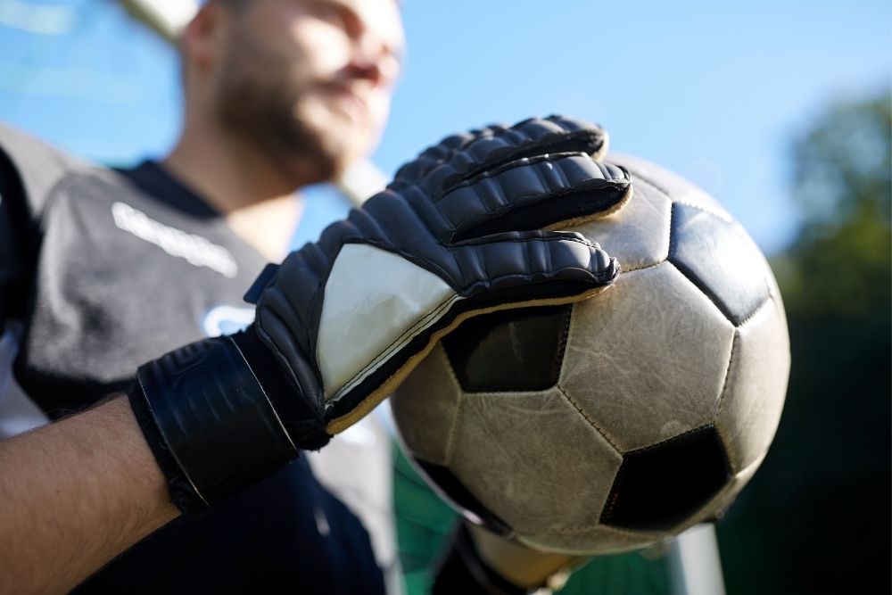 a goalie holds a soccer ball