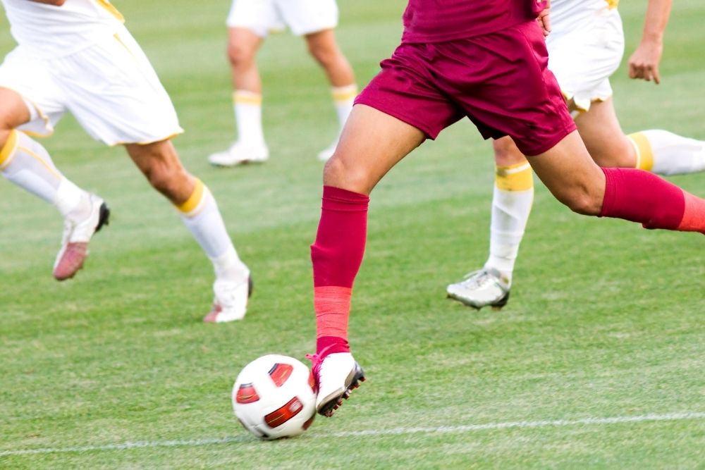 soccer player is leading a ball