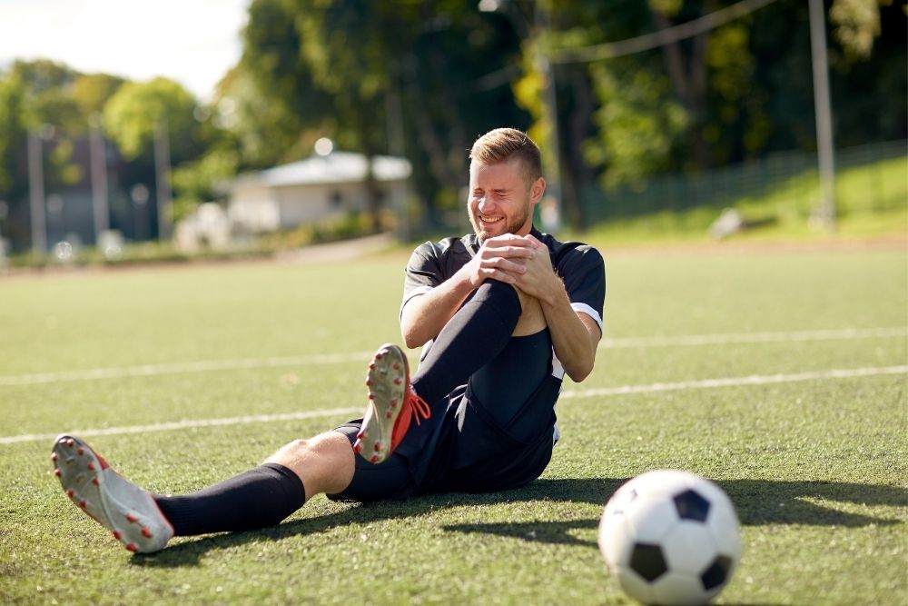 Soccer player with knee injury on the field
