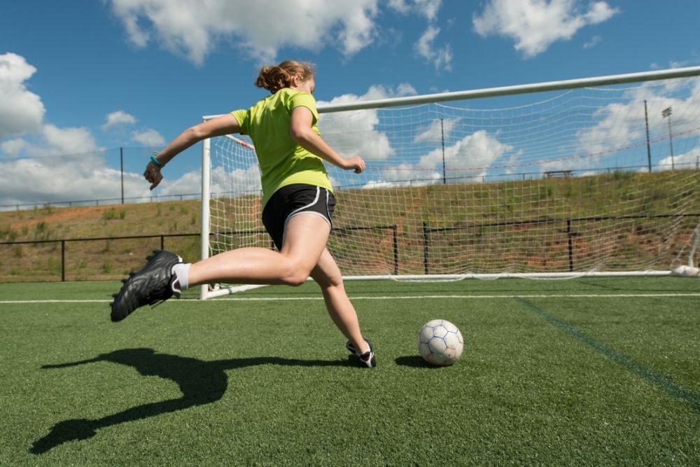 female soccer player doing a big backswing