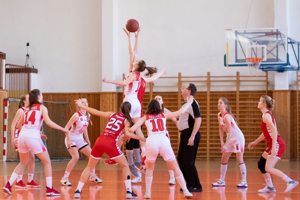 girl jumps high in a basketball match