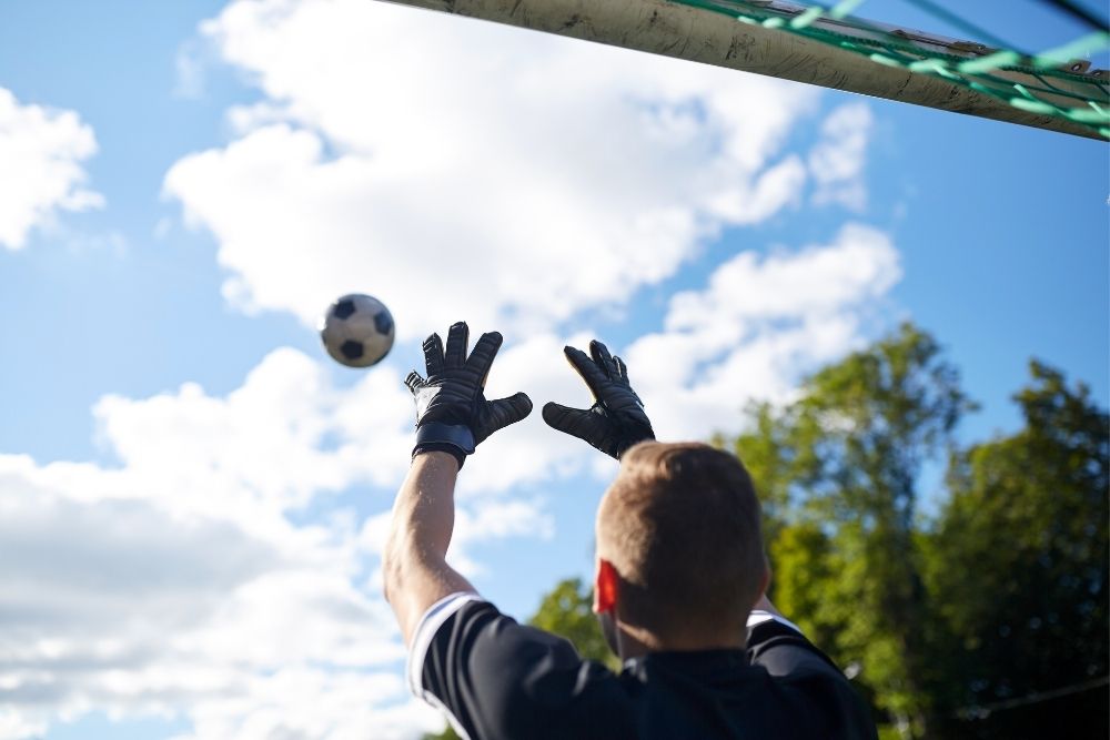 goalkeeper catching a soccer ball