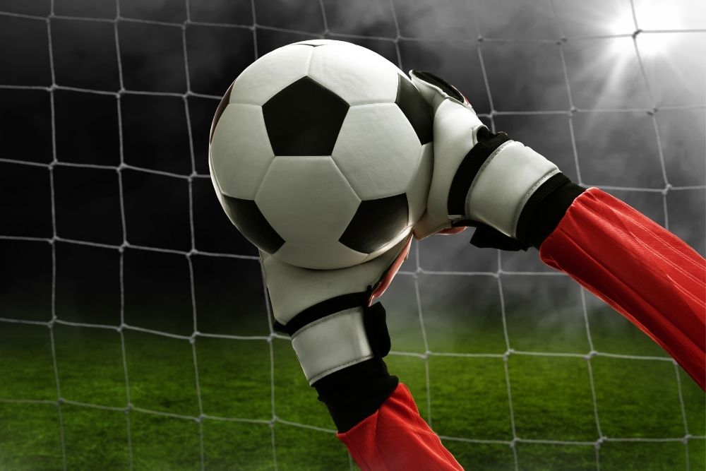 goalkeeper hands holding a soccer ball