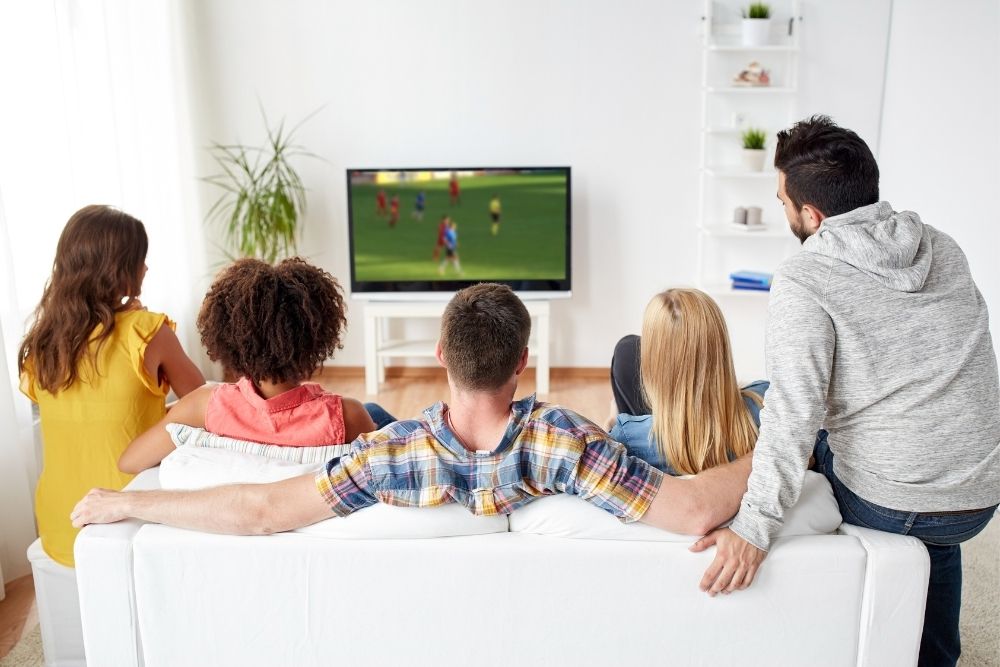 group of friends watching soccer at home