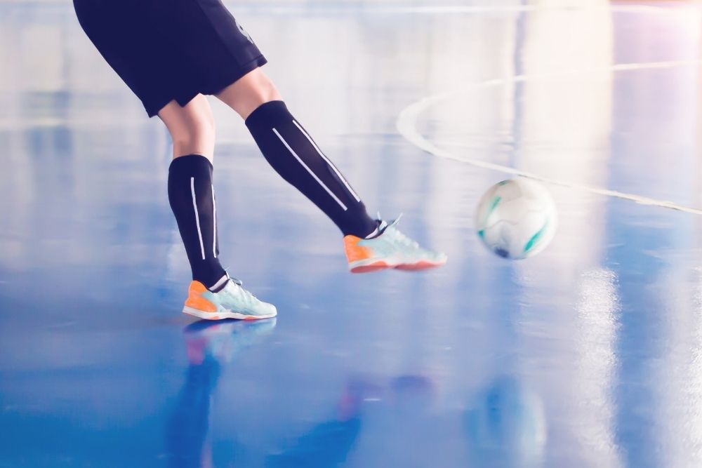 kick the ball in indoor soccer