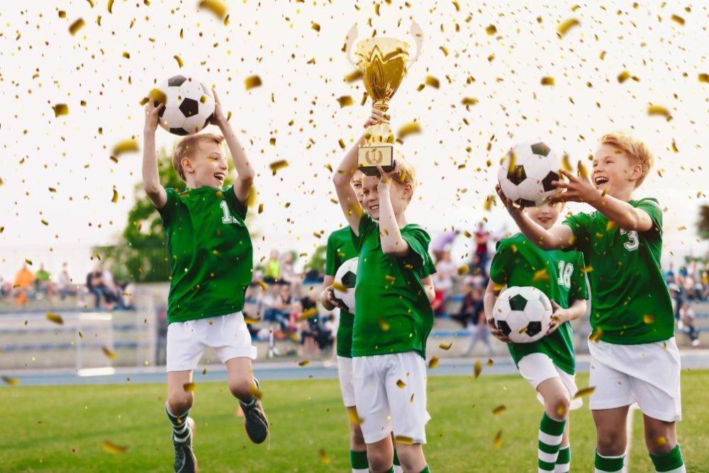 kid soccer players celebrate their win