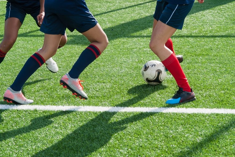 legs of soccer players in a soccer match