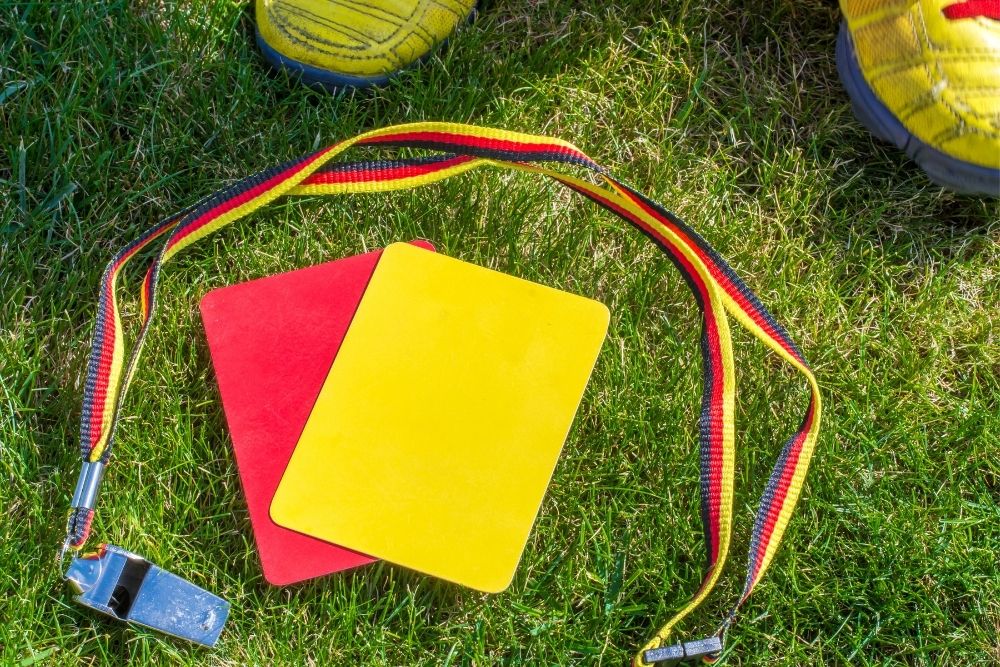 red and yellow cards and a whistle