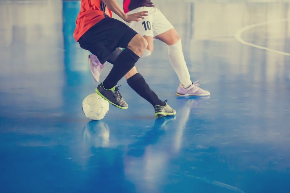 two people playing indoor soccer
