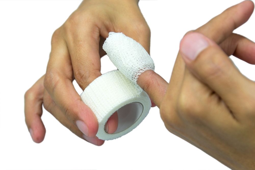 wrap white medicine bandage on broken finger