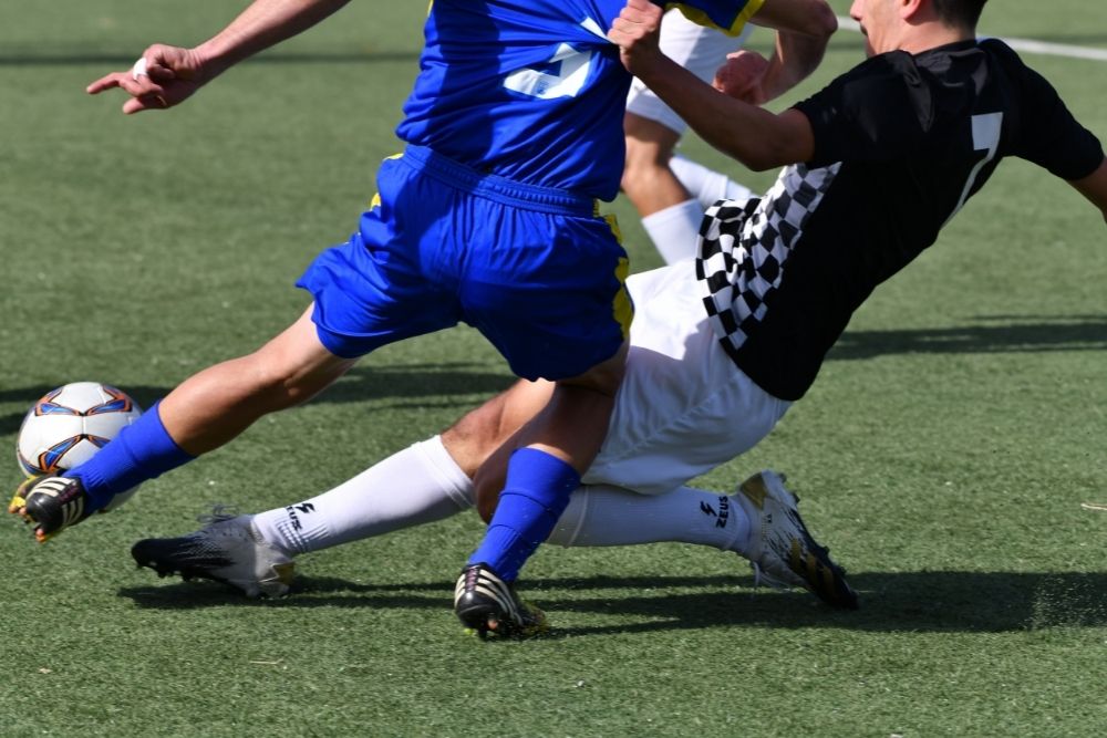 soccer player doing slide tackle