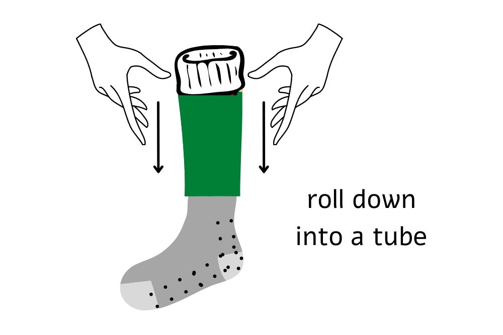 two hands rolling down a soccer sock into a tube